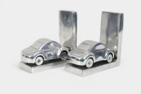 BOOKENDS: Two modern hollow metal book ends in the form of cars, 15.5cm high - 2