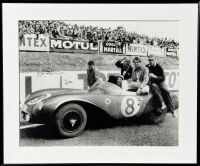 ASTON MARTIN: A pair of framed black and white photographs showing the DB3/S finishing second at Le Mans in 1956 with Peter Collins and Stirling Moss co-driving, both signed by Stirling Moss, 60cm x 50cm