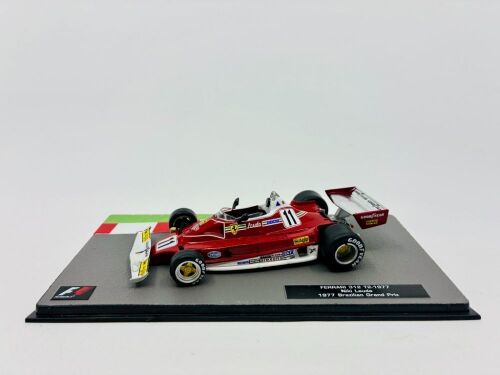 183a · FERRARI: A 1:43 scale model by IXO of the Ferrari 1977 312 T2 driven by Niki Lauda in the 1977 Brazilian Grand Prix, together with display case [Location: Sydney]