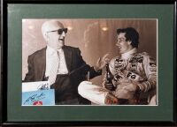 FERRARI: A framed black and white photo of Enzo Ferrari with driver Gilles Villeneuve, 38cm x 27cm