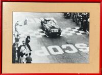 FERRARI: A framed black and white photograph of the 375 Plus '0392 AM' being driven to victory at the 1954 Carrera Panamericana by Umberto Maglioli, 50cm x 37cm