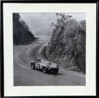 FERRARI: A framed black and white photograph of the 375 Plus '0392 AM' being driven to victory at the 1954 Carrera Panamericana by Umberto Maglioli, 37cm x 36cm