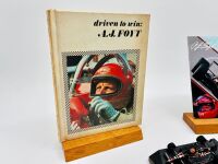 A.J. FOYT: Five A.J. Foyt Indycar items including a hardcover book, a media guide, a 1:43 scale model, a trading card and a poster [Location: Sydney] - 6