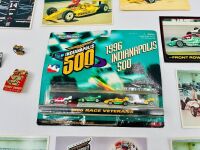 INDIANAPOLIS 500: A 1996 Micro Machine 'Indianapolis 500 Race Veterans' four car set with 19 Indy 500 postcards and nine badges [Location: Sydney] - 2