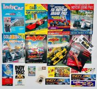 INDY CAR GOLD COAST: Eleven event programs for the Indy Car Gold Coast race together with stickers and a badge [Location: Sydney]