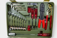AUTOMOTIVE TOOLS: A group of automotive-related tools, including a tool kit, jumper leads, a jack, a foot tyre pump and a first aid kit, all appear new to be new and of German origin - 3