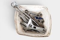 SPANNERS: A tub of spanners, comprising of adjustable and ring spanners of varied sizes