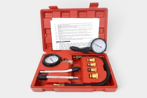 COMPRESSION TESTER: Two compression tester tools, including one complete within a case, including gauge, hose, and connectors