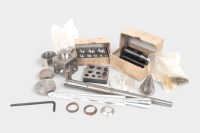 JEWELERS TOOLS: A group of tools believed to be for jewelry making or metal working purposes including dapping block, doming punches, ring sizing mandrel and others
