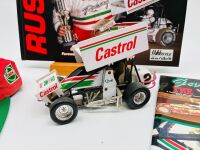 GARRY RUSH: A group of Garry rush items including a signed hat, two signed posters, a 1:24 scale model, two books and two photos [Location: Sydney] - 2