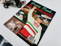 GARRY RUSH: A group of Garry rush items including a signed hat, two signed posters, a 1:24 scale model, two books and two photos [Location: Sydney] - 7