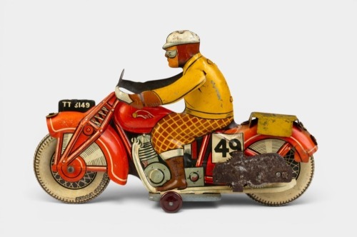 SPORTSMAN MOTORCYCLIST: A circa early 1950s Mettoy (UK) 'Sportsman' motorcyclist tinplate clockwork wind up toy, 19cm long