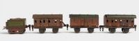 TIN TOY TRAINS: A circa 1930s or 1940s German tinplate train set, includes two passenger cars, one freight car & one coal tender, overall length 56cm - 2