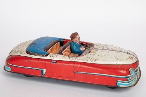 MODERN TOYS: A c1950-60s Modern Toys (Japan) tinplate open top car with driver, 23cm long