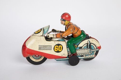 MOTORCYCLE: A c1950s-1960s Nomura (Japan) tinplate friction racing motorcycle with rider, 20cm long