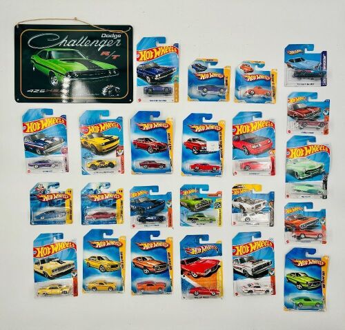 MUSCLE CARS: A group of 23 1:64 scale Hot Wheels models with a Dodge Challenger sign.