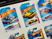 MUSCLE CARS: A group of 23 1:64 scale Hot Wheels muscle car models with a Dodge Challenger sign [Location: Sydney] - 2