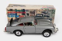 ASTON MARTIN: A c1960s United (Japan) tinplate friction Multi Action 711 Aston Martin Secret Ejector car toy (#51262), 28cm long, in original box