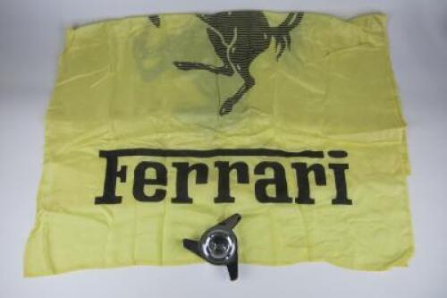 FERRARI: Two Ferrari items including a large Ferrari silk flag and a prancing horse wheel knock off.