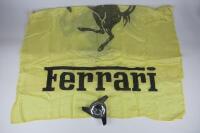 FERRARI: Two Ferrari items including a large Ferrari silk flag and a prancing horse wheel knock off.
