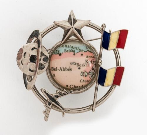 FRENCH AIR: An early 1960s large and interesting silver plate and enamel brooch, featuring French flag, airplane, moon, star and a map of North Algeria and Tunisia in the centre