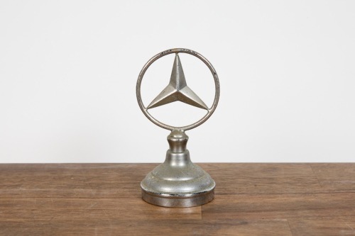 532 · MERCEDES-BENZ: A c1970s / 80s Mercedes-Benz paperweight in the form of a bonnet mascot