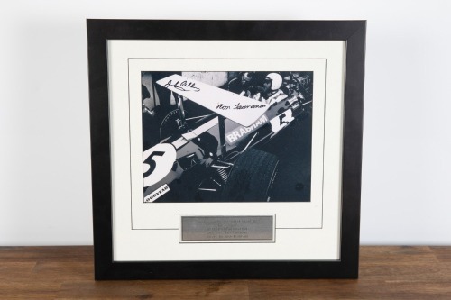 BRABHAM BT26A: A b/w photograph featuring Sir Jack sitting in a BT26A in 1969 giving Ron Tauranac feedback, hand signed by Sir Jack and Ron Tauranac