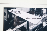 BRABHAM BT26A: A b/w photograph featuring Sir Jack sitting in a BT26A in 1969 giving Ron Tauranac feedback, hand signed by Sir Jack and Ron Tauranac - 3
