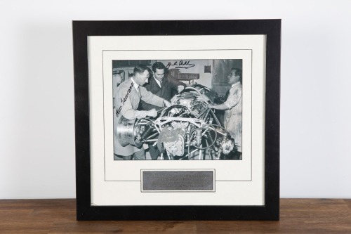 BRABHAM: A b/w photograph featuring Sir Jack & Ron Tauranac both working on the Repco-Brabham V8 engine, hand signed by Sir Jack and Ron Tauranac