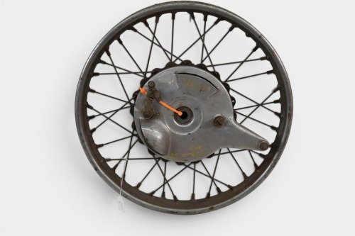 TRIUMPH: A Triumph circa early 1950s Tiger 100 wheel with 'piecrust hub' and 'S' scoop front brake, 19 inch wheel [Location: Melbourne]