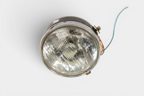 HEADLIGHT: A NOS headlight, complete, lens diameter 18cm [Location: Melbourne]