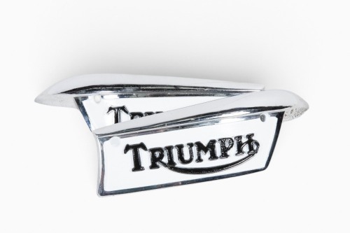 TRIUMPH: A pair of Triumph tank badges, paint by Roy Bognor [location: Melbourne]