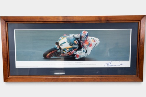MICK DOOHAN: A c1999 'Mick Doohan - Conqueror' signed print, limited edition, numbered 963/1500, 55cm high, 118cm wide overall [Location: Melbourne]