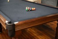 POOL TABLE: A pool / billiard table complete with triangles, pool balls, billiard balls, scoreboard, overhead lamp, cues & cue rack and table cover, thought to a nine foot tournament sized table - 7