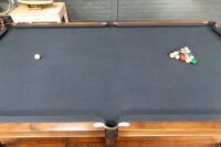 POOL TABLE: A pool / billiard table complete with triangles, pool balls, billiard balls, scoreboard, overhead lamp, cues & cue rack and table cover, thought to a nine foot tournament sized table - 9