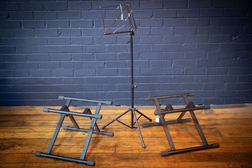 MUSIC STANDS: Three music stands, includes one sheet music stand and two amplifier stands.