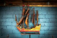 MODEL SHIP: A small ornate timber model ship on base, 62cm high from base, 50cm wide
