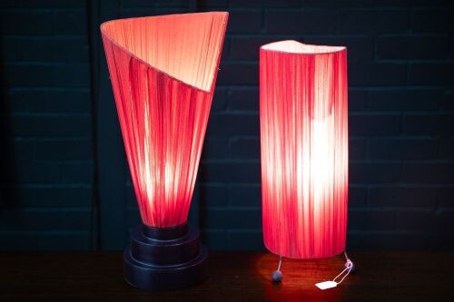 LAMPS: Two lamps with red cloth fabric 'Flame' style shades, tallest 58cm high