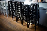 STOOLS: Twenty-nine black steel stools, most 76cm high