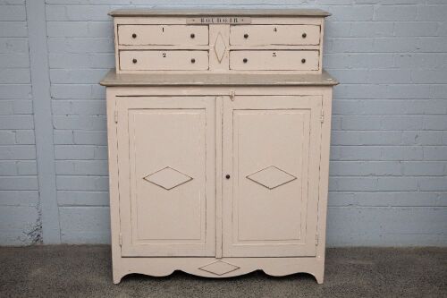 CABINET: A solid pine dresser in the French provincial style, four small drawers, two larger doors, 136cm high, 113cm wide, 47cm deep