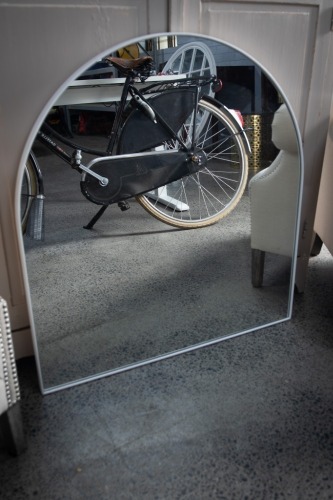 MIRROR: A large arch shaped wall mirror, 85cm high, 80cm wide