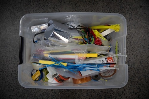 TAPES / FASTENERS: A tub of of various adhesive tapes and fasterners such as cable ties