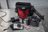 CAMERAS: Two Canon cameras, includes a 50D model with battery & strap and an older Canon instant camera