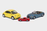 MODELS: Three model cars, including a UT Models 1:18 scale BMW Z3, a Bburago 1:18 scale 1998 Volkswagen Beetle, and a 1:43 scale Welly 1999 Ford Mustang