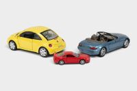 MODELS: Three model cars, including a UT Models 1:18 scale BMW Z3, a Bburago 1:18 scale 1998 Volkswagen Beetle, and a 1:43 scale Welly 1999 Ford Mustang - 2