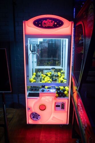 THE CLAW: A 'The Claw' aim & pick amusement machine, made by Coinopsolutions (Australia),working order