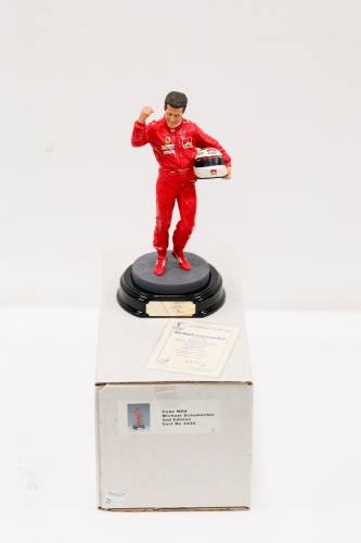 SCHUMACHER: A 1:9 scale limited edition (2430/5000) cold cast porcelain resin figure of Michael Schumacher sculpted by Tim Potts for Endurance Ltd, on wooden base with engraved plaque, NIB and accompanied by a COA from The Art of Sport, 22cm high [Locatio
