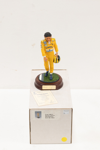 SENNA: A 1:9 scale limited edition (3943/5000) cold cast porcelain resin figure of Ayrton Senna sculpted by Paul Szeiler for Endurance Ltd, on wooden base with engraved plaque, NIB and accompanied by a COA from The Art of Sport, 22cm high [Location: Melbo