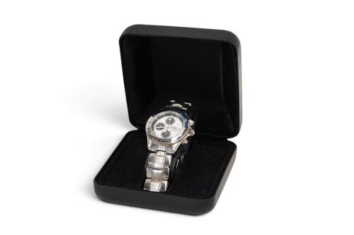WRISTWATCH: A commemorative mens analog wristwatch from the 1999 Australian Grand Prix, steel band, in case [Location: Melbourne]