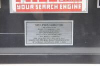LEWIS HAMILTON: A Lewis Hamilton display piece, features two photographs, a signed 'The Red Bulletin' magazine from 2008 and a achievements plaque, 56cm high, 85cm wide [Location: Melbourne] - 4